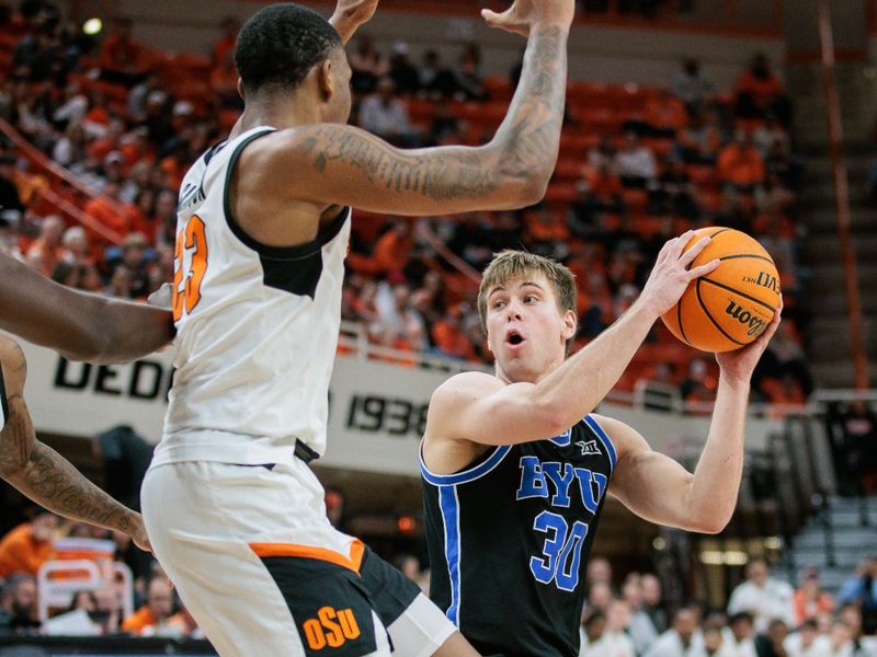 Feb 17, 2024; Stillwater, Oklahoma, USA; Brigham Young Cougars guard Dallin Hall (30) looks to pass around Oklahoma State Cowboys center Brandon Garrison (23) during the second half at Gallagher-Iba Arena. Mandatory Credit: William Purnell-USA TODAY Sports