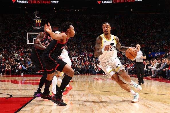 TORONTO, CANADA - DECEMBER 23:  John Collins #20 of the Utah Jazz drives to the basket during the game against the Toronto Raptors on December 23, 2023 at the Scotiabank Arena in Toronto, Ontario, Canada.  NOTE TO USER: User expressly acknowledges and agrees that, by downloading and or using this Photograph, user is consenting to the terms and conditions of the Getty Images License Agreement.  Mandatory Copyright Notice: Copyright 2023 NBAE (Photo by Vaughn Ridley/NBAE via Getty Images)