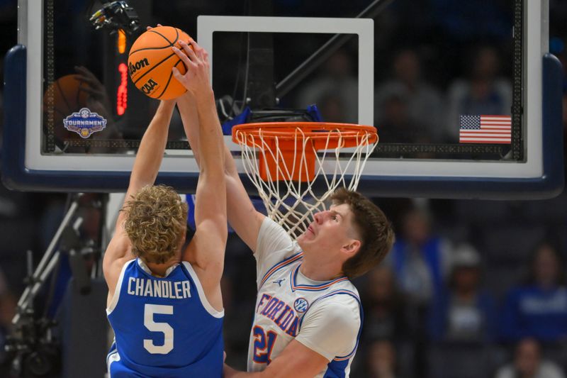 Mar 13, 2026; Nashville, TN, USA;  Florida Gators forward Alex Condon (21) blocks the shot of Kentucky Wildcats guard Collin Chandler (5) during the first half at Bridgestone Arena. Mandatory Credit: Steve Roberts-Imagn Images