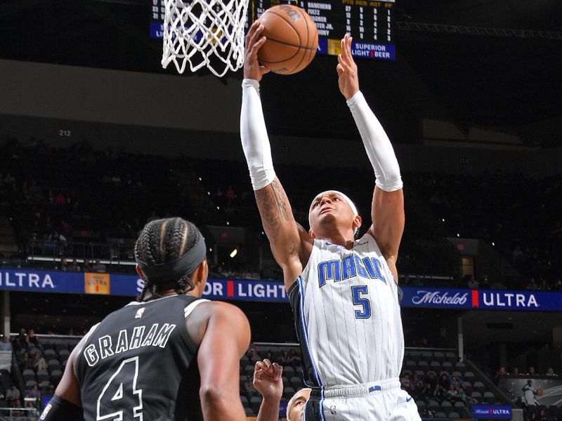 SAN ANTONIO, TX - MARCH 14: Paolo Banchero #5 of the Orlando Magic drives to the basket during the game against the San Antonio Spurs on March 14, 2023 at the AT&T Center in San Antonio, Texas. NOTE TO USER: User expressly acknowledges and agrees that, by downloading and or using this photograph, user is consenting to the terms and conditions of the Getty Images License Agreement. Mandatory Copyright Notice: Copyright 2023 NBAE (Photos by Michael Gonzales/NBAE via Getty Images)