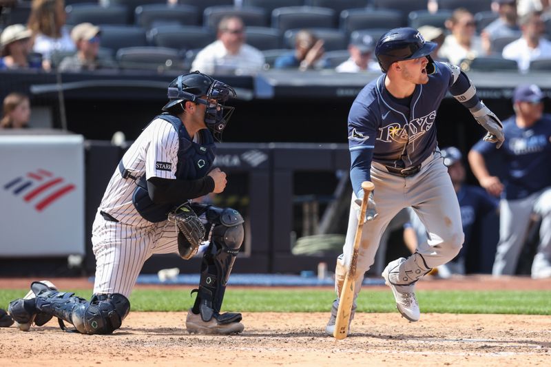 May 3, 2025; Bronx, New York, USA;  Tampa Bay Rays first baseman Curtis Mead (25) hits an RBI single in the eighth inning against the New York Yankees at Yankee Stadium. Mandatory Credit: Wendell Cruz-Imagn Images