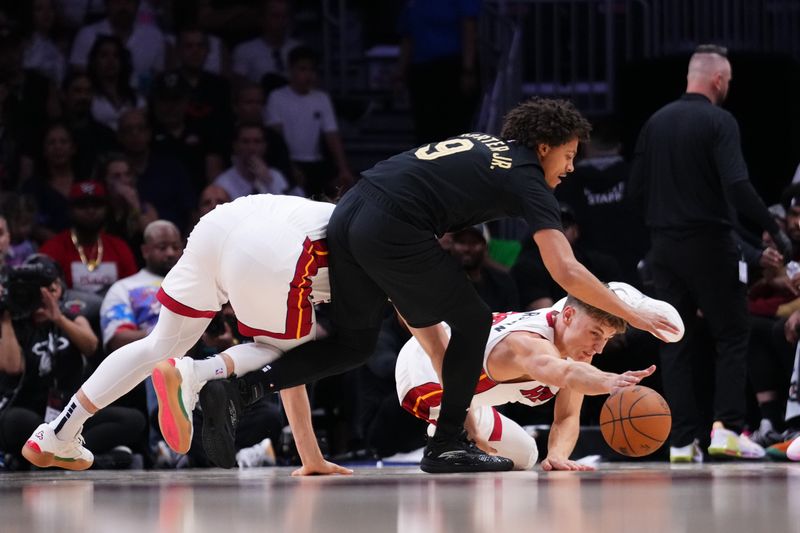 MIAMI, FLORIDA - APRIL 26: Pelle Larsson #9 of the Miami Heat and Craig Porter Jr. #9 of the Cleveland Cavaliers compete for a loose ball during the fourth quarter in Game Three of the Eastern Conference First Round NBA Playoffs at Kaseya Center on April 26, 2025 in Miami, Florida. NOTE TO USER: User expressly acknowledges and agrees that, by downloading and or using this photograph, User is consenting to the terms and conditions of the Getty Images License Agreement. (Photo by Rich Storry/Getty Images)