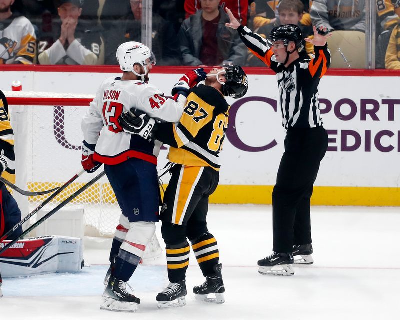 Jan 2, 2024; Pittsburgh, Pennsylvania, USA;  Washington Capitals right wing Tom Wilson (43) gets physical with Pittsburgh Penguins center Sidney Crosby (87) after stoppage in play during the third period at PPG Paints Arena. Mandatory Credit: Charles LeClaire-USA TODAY Sports