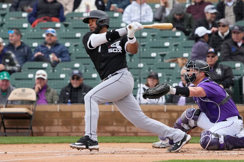 Mar 2, 2023; Salt River Pima-Maricopa, Arizona, USA; Chicago White Sox shortstop Elvis Andrus (1) hits a double against the Colorado Rockies in the first inning at Salt River Fields at Talking Stick. Mandatory Credit: Rick Scuteri-USA TODAY Sports