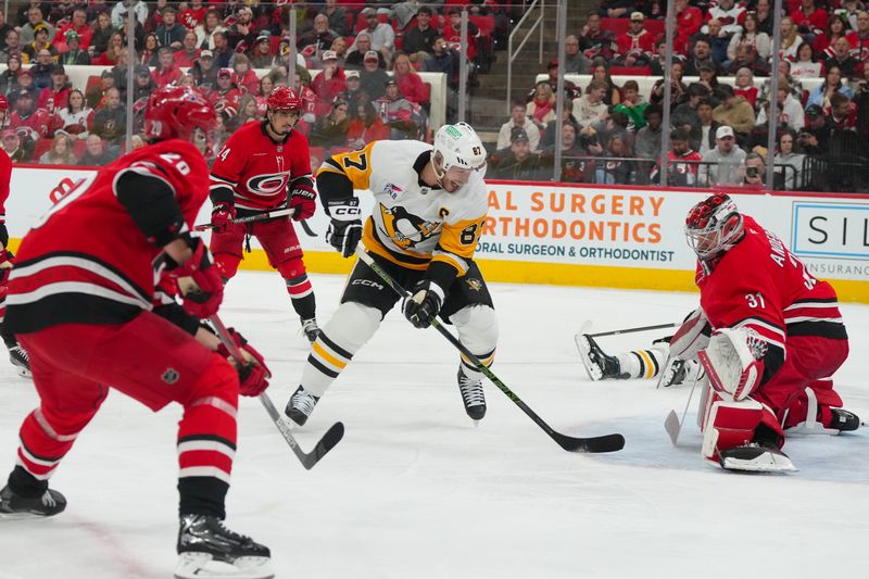 Mar 18, 2026; Raleigh, North Carolina, USA;  Pittsburgh Penguins center Sidney Crosby (87) scores a gaol past Carolina Hurricanes goaltender Frederik Andersen (31) during the second period at Lenovo Center. Mandatory Credit: James Guillory-Imagn Images