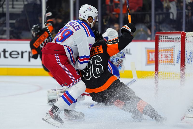 Nov 29, 2024; Philadelphia, Pennsylvania, USA; Philadelphia Flyers left wing Joel Farabee (86) reacts against New York Rangers defenseman K'Andre Miller (79) as Philadelphia Flyers right wing Travis Konecny (11) celebrates after scoring a goal in the first period at Wells Fargo Center. Mandatory Credit: Kyle Ross-Imagn Images