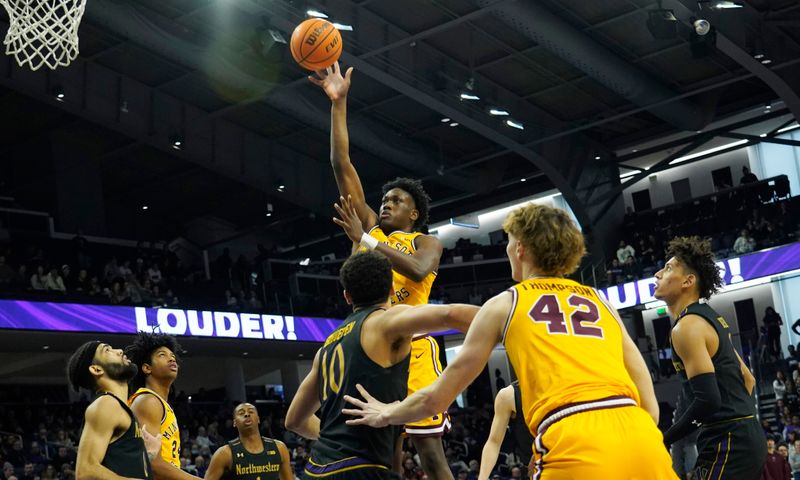 Jan 28, 2023; Evanston, Illinois, USA; Minnesota Golden Gophers forward Joshua Ola-Joseph (1) shoots over Northwestern Wildcats forward Tydus Verhoeven (10) during the first half at Welsh-Ryan Arena. Mandatory Credit: David Banks-USA TODAY Sports