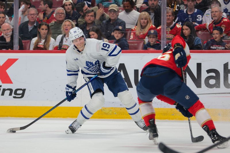 Apr 8, 2025; Sunrise, Florida, USA; Toronto Maple Leafs center Calle Jarnkrok (19) shoots the puck against the Florida Panthers during the first period at Amerant Bank Arena. Mandatory Credit: Sam Navarro-Imagn Images
