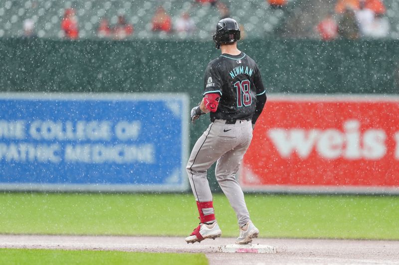 May 12, 2024; Baltimore, Maryland, USA; Arizona Diamondbacks shortstop Kevin Newman (18) runs out a double against the Baltimore Orioles during the seventh inning at Oriole Park at Camden Yards. Mandatory Credit: Gregory Fisher-USA TODAY Sports