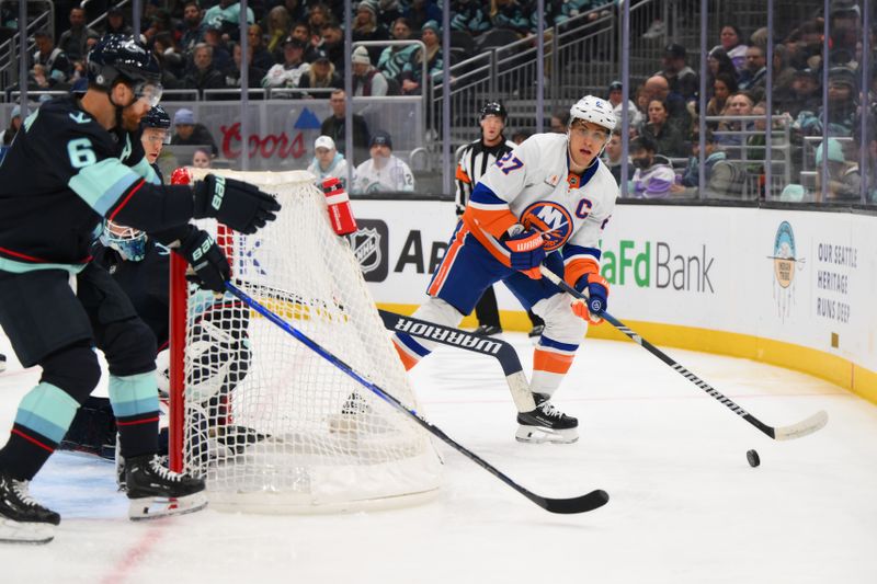 Nov 16, 2024; Seattle, Washington, USA; New York Islanders left wing Anders Lee (27) plays the puck during the second period against the Seattle Kraken at Climate Pledge Arena. Mandatory Credit: Steven Bisig-Imagn Images