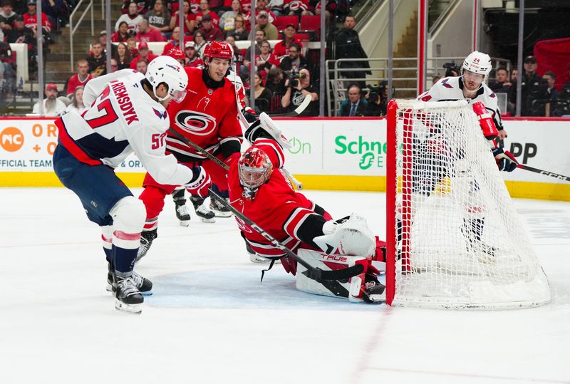 Apr 2, 2025; Raleigh, North Carolina, USA;  Carolina Hurricanes goaltender Frederik Andersen (31) stops the scoring attempt by Washington Capitals defenseman Trevor van Riemsdyk (57) during the second period at Lenovo Center. Mandatory Credit: James Guillory-Imagn Images