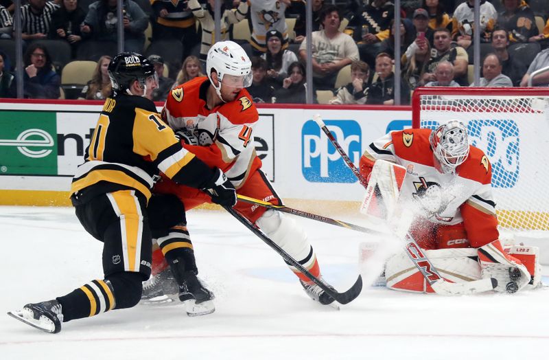 Oct 31, 2024; Pittsburgh, Pennsylvania, USA;  Anaheim Ducks goaltender Lukas Dostal (1) makes save against Pittsburgh Penguins left wing Drew O'Connor (10) as Ducks defenseman Cam Fowler (4) defends during the third period at PPG Paints Arena. Mandatory Credit: Charles LeClaire-Imagn Images