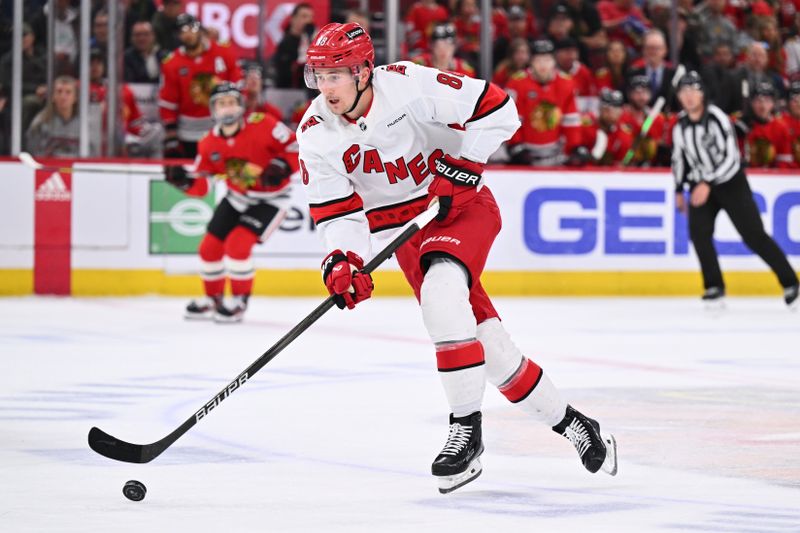 Apr 14, 2024; Chicago, Illinois, USA;  Carolina Hurricanes forward Martin Necas (88) controls the puck in the second period against the Chicago Blackhawks at United Center. Mandatory Credit: Jamie Sabau-USA TODAY Sports