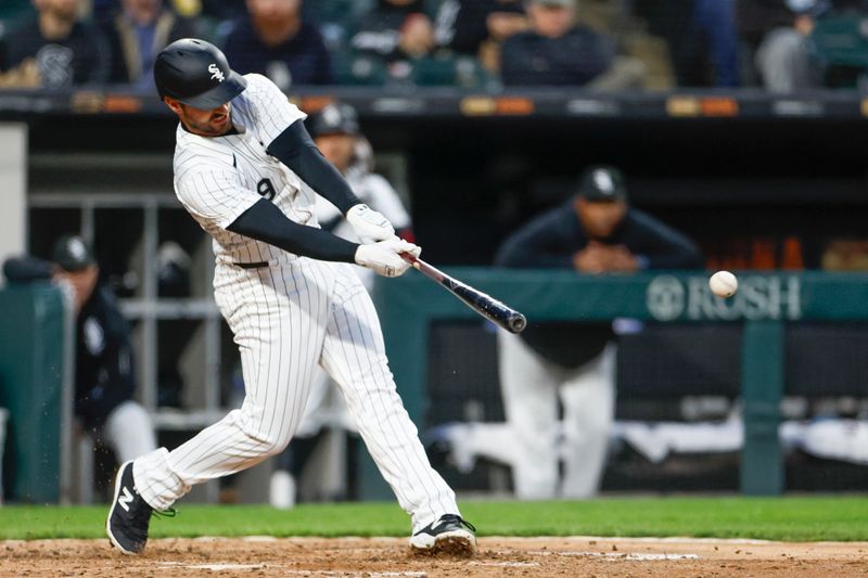 Apr 26, 2024; Chicago, Illinois, USA; Chicago White Sox shortstop Paul DeJong (29) hits an RBI-single against the Tampa Bay Rays during the fourth inning at Guaranteed Rate Field. Mandatory Credit: Kamil Krzaczynski-USA TODAY Sports