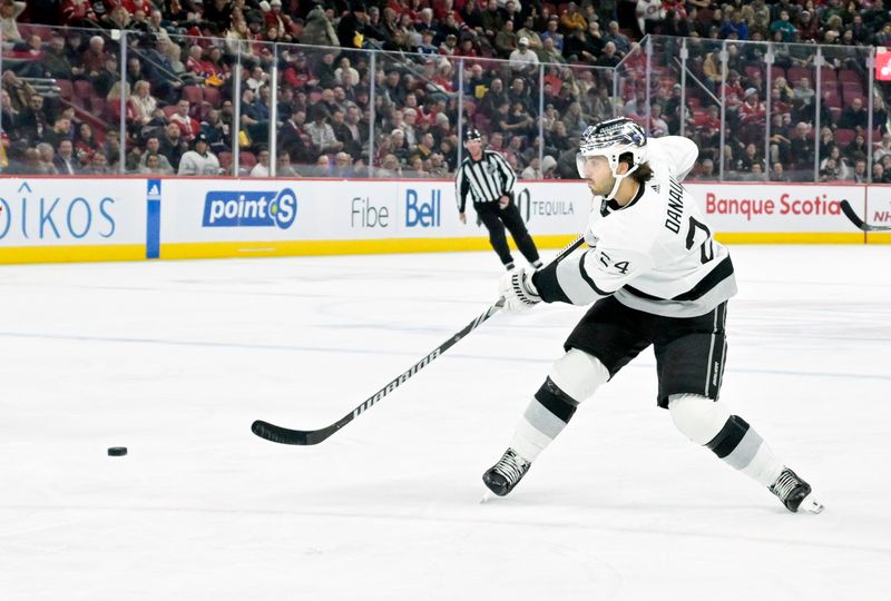 Dec 7, 2023; Montreal, Quebec, CAN; Los Angeles Kings forward Philllip Danault (24) takes a shot on the Montreal Canadiens net during the third period at the Bell Centre. Mandatory Credit: Eric Bolte-USA TODAY Sports