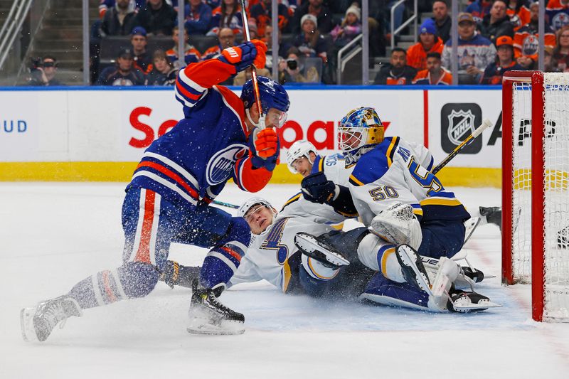 Feb 28, 2024; Edmonton, Alberta, CAN; Edmonton Oilers forward Derek Ryan (10) looks for a loose puck beside St. Louis Blues goaltender Jordan Binnington (50) during the first period at Rogers Place. Mandatory Credit: Perry Nelson-USA TODAY Sports