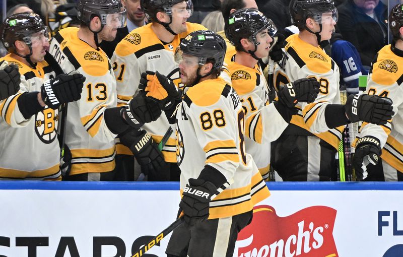 Dec 2, 2023; Toronto, Ontario, CAN; Boston Bruins forward David Pastrnak (88) celebrates with team mates at the bench after scoring against the Toronto Maple Leafs in the first period at Scotiabank Arena. Mandatory Credit: Dan Hamilton-USA TODAY Sports