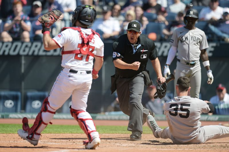 Apr 23, 2025; Cleveland, Ohio, USA; Home pate umpire Mark Ripperger (90) makes the ball after Cleveland Guardians catcher Austin Hedges (27) tagged out New York Yankees center fielder Cody Bellinger (35) during the sixth inning at Progressive Field. Mandatory Credit: Ken Blaze-Imagn Images