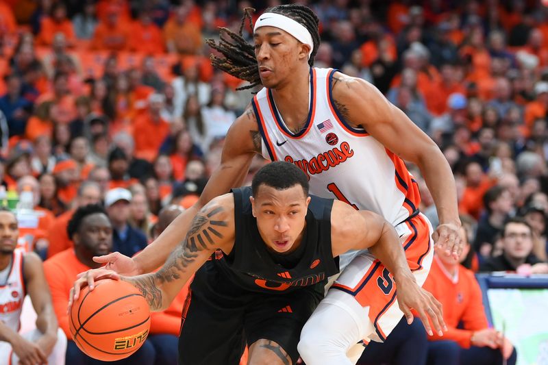 Jan 20, 2024; Syracuse, New York, USA; Miami (Fl) Hurricanes guard Matthew Cleveland (0) drives to the basket against the defense of Syracuse Orange forward Maliq Brown (1) during the first half at the JMA Wireless Dome. Mandatory Credit: Rich Barnes-USA TODAY Sports