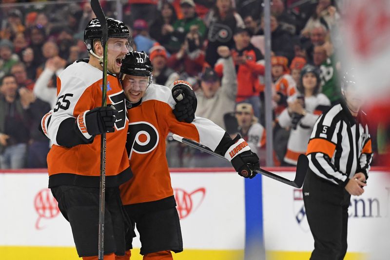 Jan 27, 2025; Philadelphia, Pennsylvania, USA; Philadelphia Flyers right wing Bobby Brink (10) celebrates his goal with defenseman Rasmus Ristolainen (55) against the New Jersey Devils during the first period at Wells Fargo Center. Mandatory Credit: Eric Hartline-Imagn Images