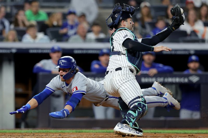 Sep 9, 2024; Bronx, New York, USA; Kansas City Royals shortstop Bobby Witt Jr. (7) scores a run against New York Yankees catcher Austin Wells (28) on a single by Royals catcher Salvador Perez (not pictured) during the fifth inning at Yankee Stadium. Mandatory Credit: Brad Penner-Imagn Images