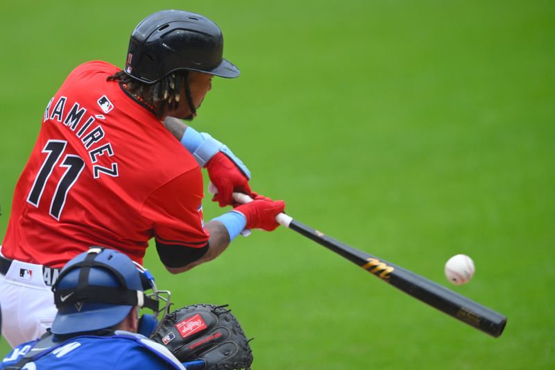Jun 23, 2024; Cleveland, Ohio, USA; Cleveland Guardians designated hitter Jose Ramirez (11) singles in the first inning against the Toronto Blue Jays at Progressive Field. Mandatory Credit: David Richard-USA TODAY Sports