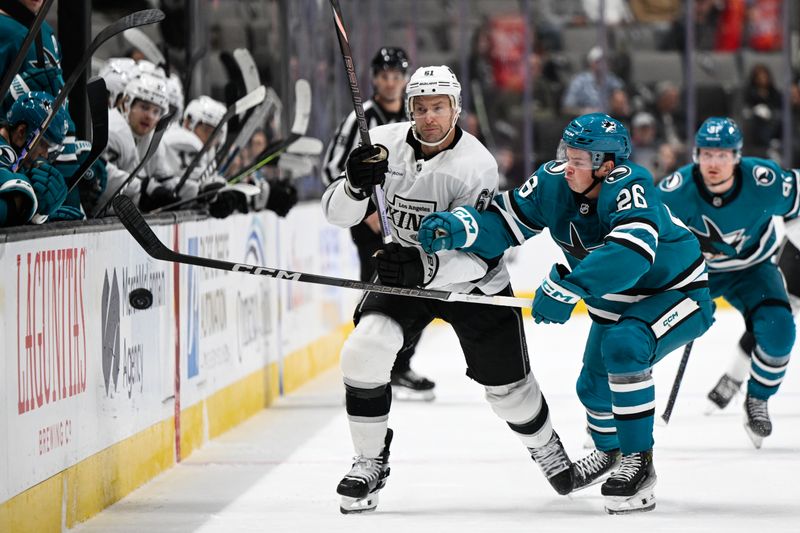 Oct 29, 2024; San Jose, California, USA; San Jose Sharks defenseman Jack Thompson (26) and Los Angeles Kings center Trevor Lewis (61) battle for the puck in the first period at SAP Center at San Jose. Mandatory Credit: Eakin Howard-Imagn Images