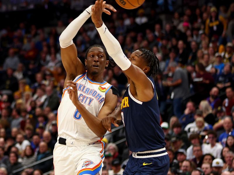 DENVER, COLORADO - NOVEMBER 6: Jalen Williams #8 of the Oklahoma City Thunder makes a pass against Peyton Watson #8 of the Denver Nuggets in the second half at Ball Arena on November 6, 2024 in Denver, Colorado. NOTE TO USER: User expressly acknowledges and agrees that, by downloading and/or using this Photograph, user is consenting to the terms and conditions of the Getty Images License Agreement. (Photo by Jamie Schwaberow/Getty Images)