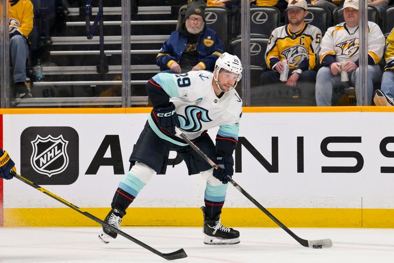 Mar 19, 2026; Nashville, Tennessee, USA;  dSeattle Kraken defenseman Vince Dunn (29) skates with the puck against the Nashville Predators uring the first period at Bridgestone Arena. Mandatory Credit: Steve Roberts-Imagn Images