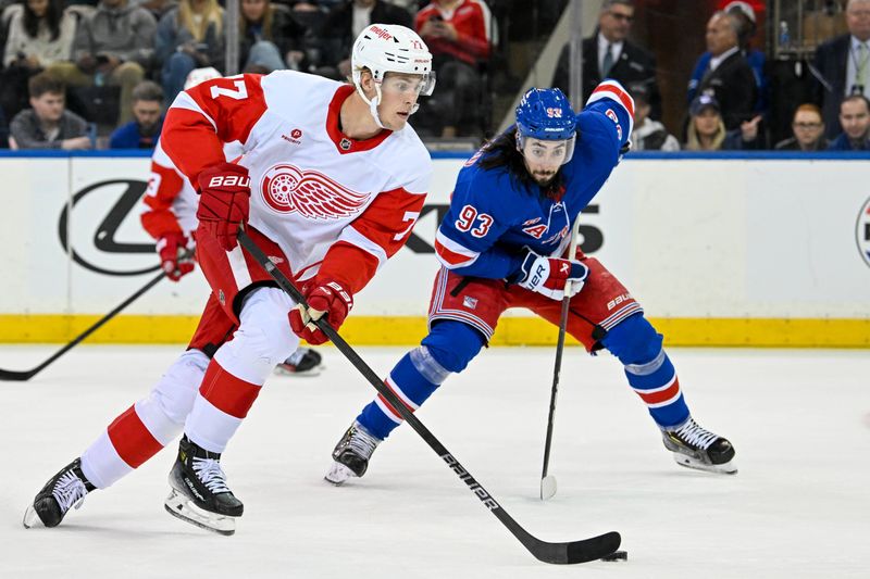 Oct 14, 2024; New York, New York, USA;  Detroit Red Wings defenseman Simon Edvinsson (77) skates with the puck while defended by New York Rangers center Mika Zibanejad (93) during the second period at Madison Square Garden. Mandatory Credit: Dennis Schneidler-Imagn Images