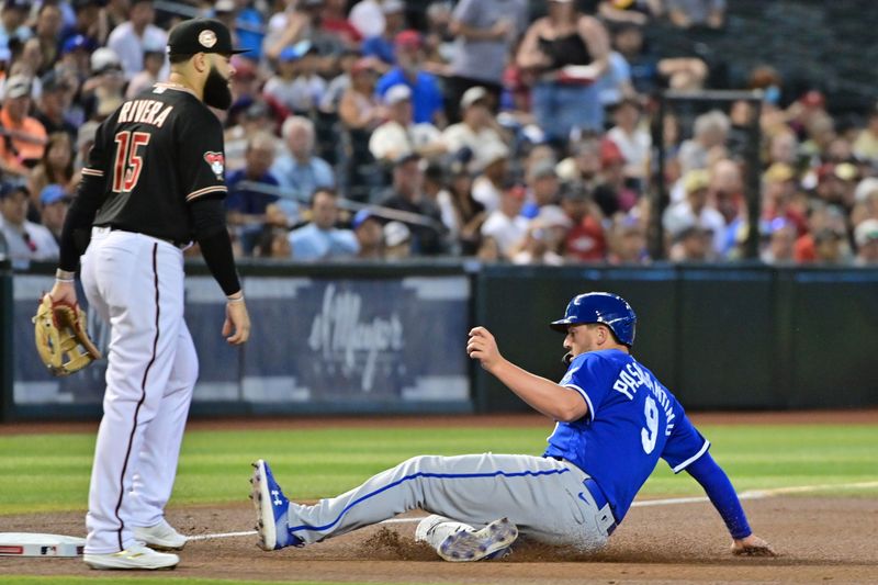 Apr 26, 2023; Phoenix, Arizona, USA; Kansas City Royals first baseman Vinnie Pasquantino (9) slides into third base as Arizona Diamondbacks third baseman Emmanuel Rivera (15) looks on in the first inning at Chase Field. Mandatory Credit: Matt Kartozian-USA TODAY Sports