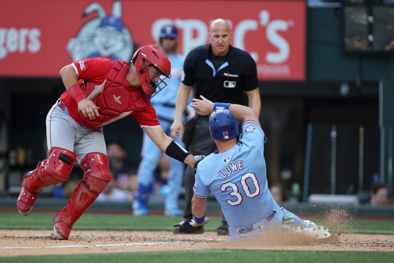 Sep 8, 2024; Arlington, Texas, USA; Los Angeles Angels catcher Matt Thaiss (21) tags out Texas Rangers first base Nathaniel Lowe (30) at home in the eighth inning at Globe Life Field. Mandatory Credit: Tim Heitman-Imagn Images