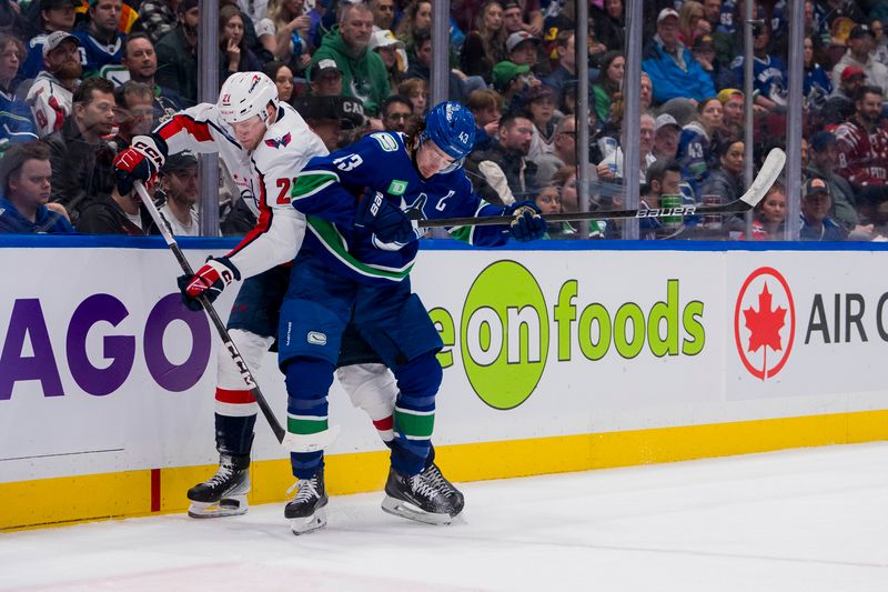 Mar 16, 2024; Vancouver, British Columbia, CAN; Vancouver Canucks defenseman Quinn Hughes (43) checks Washington Capitals forward Aliaksei Protas (21) in the second period at Rogers Arena. Mandatory Credit: Bob Frid-USA TODAY Sports