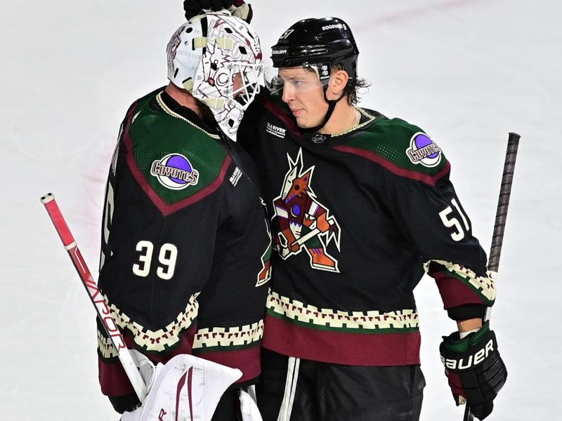 Nov 2, 2023; Tempe, Arizona, USA;  Arizona Coyotes goaltender Connor Ingram (39) celebrates with defenseman Troy Stecher (51) after beating the Montreal Canadiens at Mullett Arena. Mandatory Credit: Matt Kartozian-USA TODAY Sports