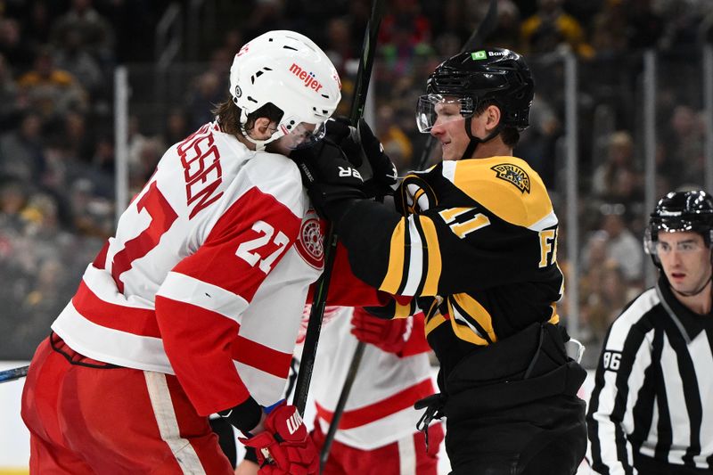 Dec 3, 2024; Boston, Massachusetts, USA; Boston Bruins center Trent Frederic (11) shoves Detroit Red Wings center Michael Rasmussen (27) after the whistle during the second period at the TD Garden. Mandatory Credit: Brian Fluharty-Imagn Images