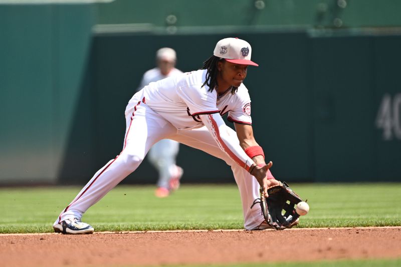 Jul 4, 2024; Washington, District of Columbia, USA; Washington Nationals shortstop CJ Abrams (5).fields a ground ball against the New York Mets during the second inning at Nationals Park. Mandatory Credit: Rafael Suanes-USA TODAY Sports