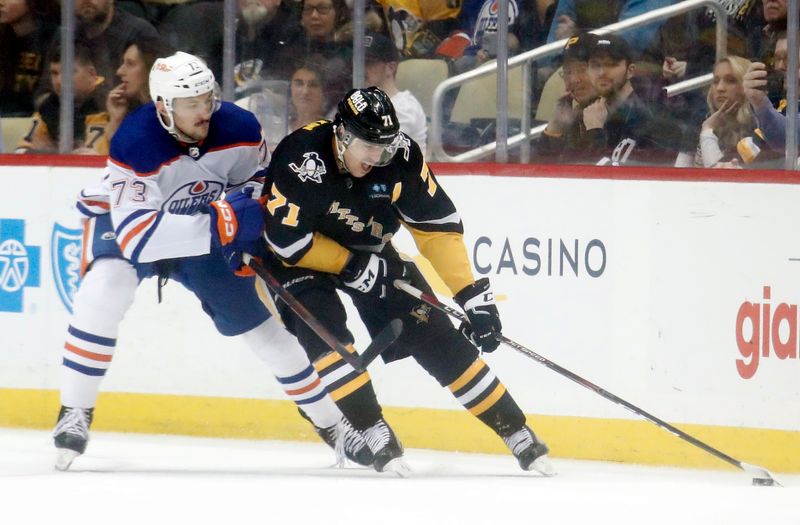 Feb 23, 2023; Pittsburgh, Pennsylvania, USA;  Pittsburgh Penguins center Evgeni Malkin (71) moves the puck against Edmonton Oilers defenseman Vincent Desharnais (73)  during the second period at PPG Paints Arena. Edmonton won 7-2. Mandatory Credit: Charles LeClaire-USA TODAY Sports