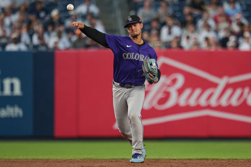 Aug 23, 2024; Bronx, New York, USA; Colorado Rockies shortstop Ezequiel Tovar (14) throws the ball to first base for an out during the second inning against the New York Yankees at Yankee Stadium. Mandatory Credit: Vincent Carchietta-USA TODAY Sports