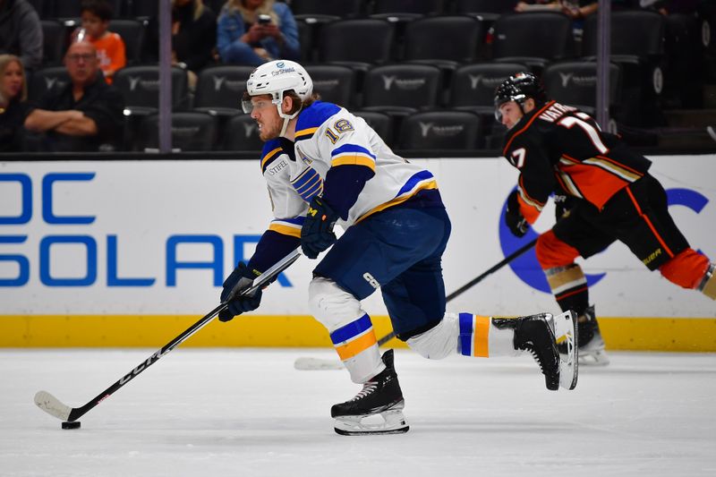 Apr 7, 2024; Anaheim, California, USA; St. Louis Blues center Robert Thomas (18) moves the puck ahead of Anaheim Ducks right wing Frank Vatrano (77) during the second period at Honda Center. Mandatory Credit: Gary A. Vasquez-USA TODAY Sports