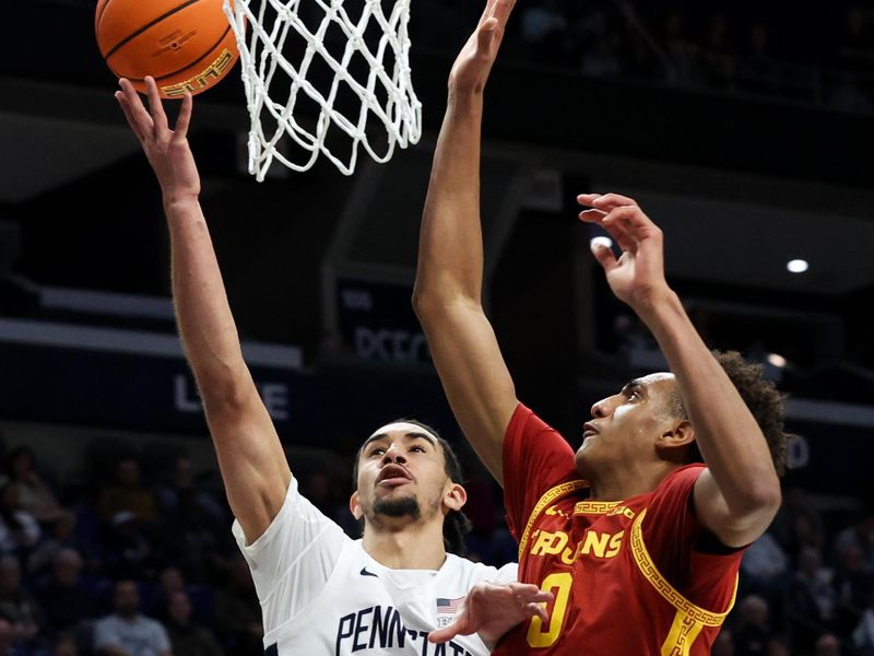 Feb 8, 2026; University Park, Pennsylvania, USA; Penn State Nittany Lions guard Freddie Dilione V (5) drives the ball to the basket as Southern California Trojans guard Alijah Arenas (0) defends during the first half at Bryce Jordan Center. Mandatory Credit: Matthew O'Haren-Imagn Images
