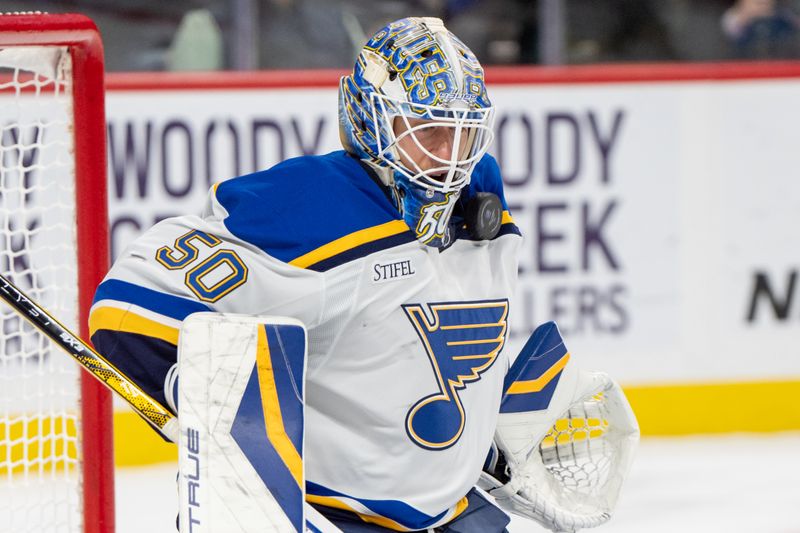 Jan 7, 2025; Saint Paul, Minnesota, USA; St. Louis Blues goaltender Jordan Binnington (50) makes a save against the Minnesota Wild in the second period at Xcel Energy Center. Mandatory Credit: Matt Blewett-Imagn Images