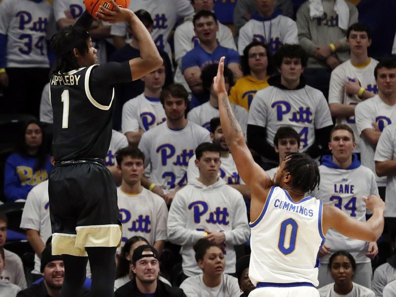 Jan 25, 2023; Pittsburgh, Pennsylvania, USA; Wake Forest Demon Deacons guard Tyree Appleby (1) shoots a three point basket over Pittsburgh Panthers guard Nelly Cummings (0) during the first half at the Petersen Events Center. Mandatory Credit: Charles LeClaire-USA TODAY Sports