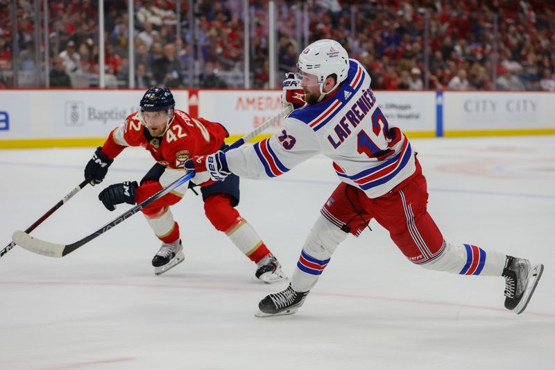 May 28, 2024; Sunrise, Florida, USA; New York Rangers left wing Alexis Lafreniere (13) shoots the puck against the Florida Panthers during the first period in game four of the Eastern Conference Final of the 2024 Stanley Cup Playoffs at Amerant Bank Arena. Mandatory Credit: Sam Navarro-USA TODAY Sports