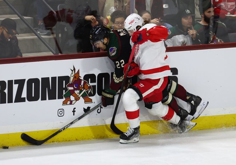 Jan 17, 2023; Tempe, Arizona, USA; Arizona Coyotes center Jack McBain (22) is checked into the boards by Detroit Red Wings center Oskar Sundqvist (70) in the second period at Mullett Arena. Mandatory Credit: Mark J. Rebilas-USA TODAY Sports