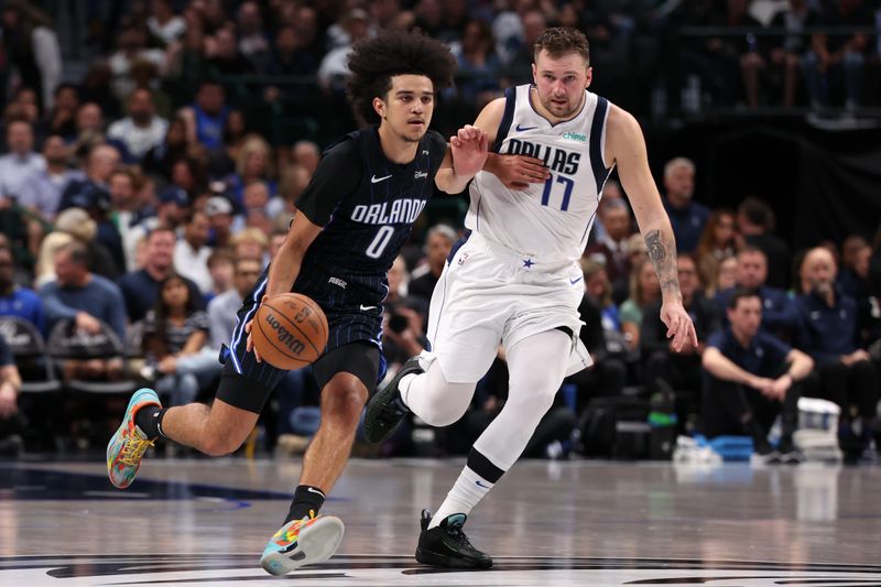 DALLAS, TEXAS - NOVEMBER 03: Anthony Black #0 of the Orlando Magic drives with the ball in front of Luka Doncic #77 of the Dallas Mavericks during the first half at American Airlines Center on November 03, 2024 in Dallas, Texas. NOTE TO USER: User expressly acknowledges and agrees that, by downloading and or using this photograph, User is consenting to the terms and conditions of the Getty Images License Agreement. (Photo by Sam Hodde/Getty Images)