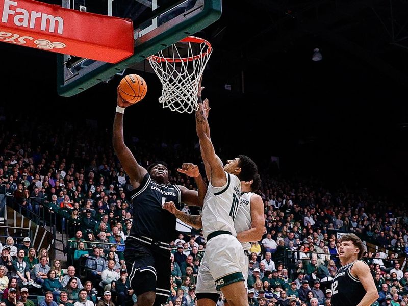 Feb 17, 2024; Fort Collins, Colorado, USA; Utah State Aggies forward Great Osobor (1) drives to the net against Colorado State Rams guard Nique Clifford (10) and forward Joel Scott (1) as forward Jackson Grant (21) looks on in the first half at Moby Arena. Mandatory Credit: Isaiah J. Downing-USA TODAY Sports