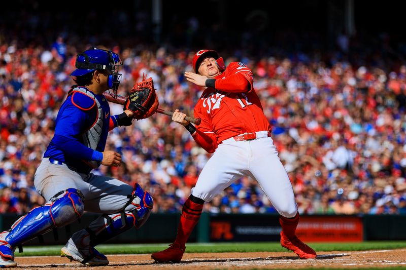 May 24, 2025; Cincinnati, Ohio, USA; Cincinnati Reds designated hitter Austin Hays (12) dodges a pitch in the fifth inning against the Chicago Cubs at Great American Ball Park. Mandatory Credit: Katie Stratman-Imagn Images