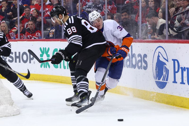 Apr 15, 2024; Newark, New Jersey, USA; New Jersey Devils defenseman Kevin Bahl (88) hits New York Islanders center Kyle MacLean (32) during the first period at Prudential Center. Mandatory Credit: Ed Mulholland-USA TODAY Sports