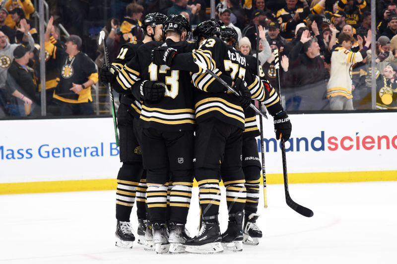 Feb 6, 2024; Boston, Massachusetts, USA; Boston Bruins left wing James van Riemsdyk (21) center Charlie Coyle (13) and defenseman Charlie McAvoy (73) celebrate a goal during the third period against the Calgary Flames at TD Garden. Mandatory Credit: Bob DeChiara-USA TODAY Sports