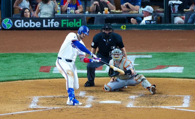 Jun 5, 2024; Arlington, Texas, USA;  Texas Rangers catcher Jonah Heim (28) hits a two-run home run during the third inning against the Detroit Tigers at Globe Life Field. Mandatory Credit: Kevin Jairaj-USA TODAY Sports